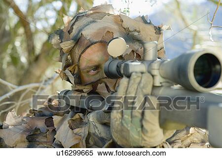Soldier aiming through gunsight outdoors (close-up) View Large Photo Image Stock Photography - Soldier aiming through gunsight outdoors (close-up). Fotosearch