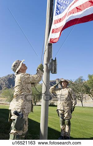 Soldiers raising United States flag outdoors View Large Photo Image Stock Image - Soldiers raising United States flag outdoors. Fotosearch