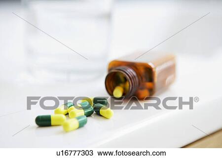 Spilt bottle of pills on counter close up View Large Photo Image Stock Image - Spilt bottle of pills on counter close up. Fotosearch