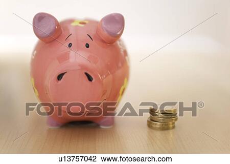 Stack of gold coins standing next to piggy bank View Large Photo Image Stock Image - Stack of gold coins standing next to piggy bank. Fotosearch