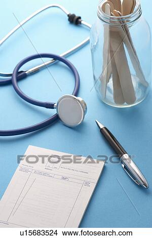 Stethoscope pen notepad and jar of sticks on doctors table View Large Photo Image Picture - Stethoscope pen notepad and jar of sticks on doctors table. Fotosearch