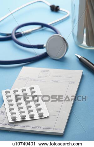 Stock Image - Stethoscope prescription and medication on doctors table. Fotosearch