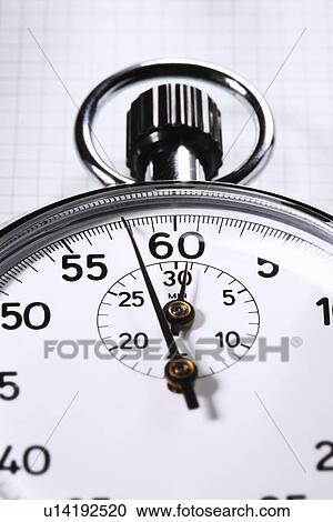 Stock Image - Stopwatch on graph paper cropped. Fotosearch