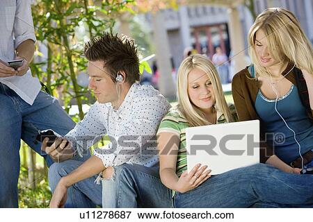 Stock Photo - Students relaxing outdoors. Fotosearch