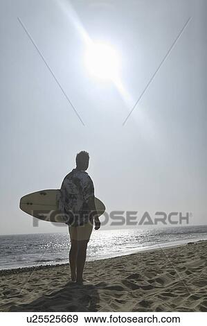 Stock Photo - Surfer on beach. Fotosearch
