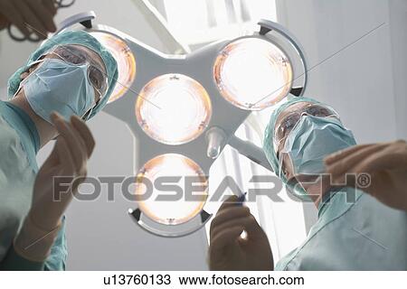 Surgeons preparing to operate in operating theatre personal perspective View Large Photo Image Stock Image - Surgeons preparing to operate in operating theatre personal perspective. Fotosearch