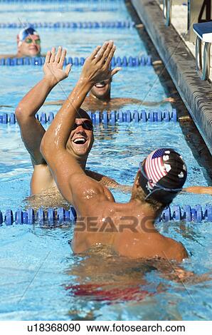 Stock Image - Swimmers High-Fiving. Fotosearch