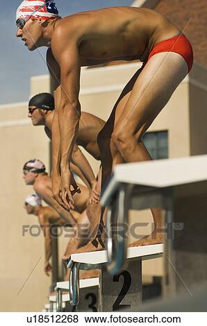 Stock Photo - Swimmers Lined Up at Starting Blocks. Fotosearch