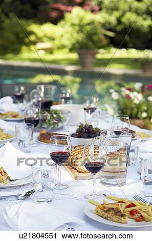 Table full of food and wine in backyard View Large Photo Image Stock Image - Table full of food and wine in backyard. Fotosearch