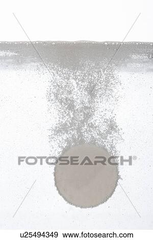 Stock Photo - Tablet sinking in water close-up. Fotosearch