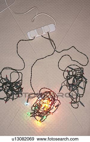 Tangled Christmas lights on floor elevated view View Large Photo Image Stock Photo - Tangled Christmas lights on floor elevated view. Fotosearch