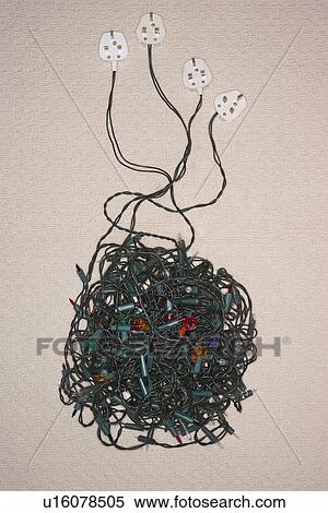 Stock Photography - Tangled Christmas lights on floor view from above. Fotosearch