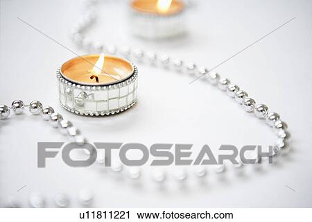 Tea light Candles and Silver Garland close up View Large Photo Image Stock Image - Tea light Candles and Silver Garland close up. Fotosearch