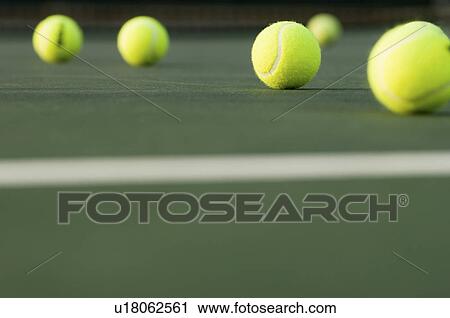 Stock Image - Tennis Balls lying on Court ground view. Fotosearch
