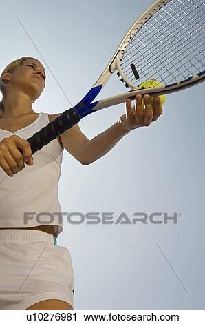 Tennis Player holding ball and racket Preparing to Serve low angle view View Large Photo Image Stock Image - Tennis Player holding ball and racket Preparing to Serve low angle view. Fotosearch