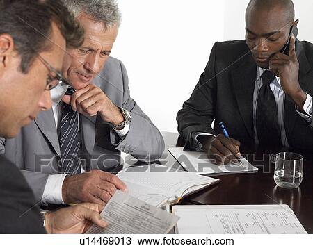Stock Image - Three businessmen in conference meeting. Fotosearch