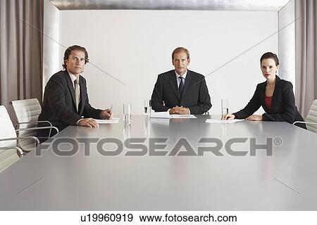 Stock Photo - Three Businesspeople in Conference Room. Fotosearch