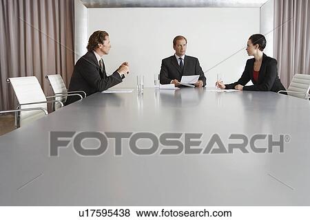 Three Businesspeople Meeting in Conference Room View Large Photo Image Stock Photo - Three Businesspeople Meeting in Conference Room. Fotosearch