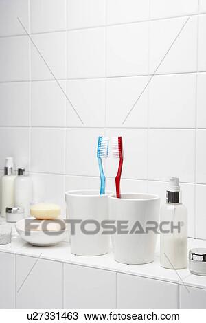 Toothbrushes face to face on shelf in white bathroom View Large Photo Image Stock Image - Toothbrushes face to face on shelf in white bathroom. Fotosearch