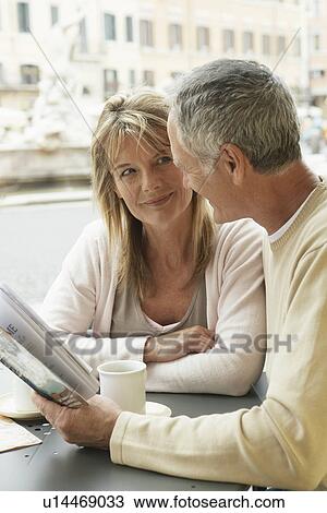 Stock Image - Tourist Couple in Cafe. Fotosearch