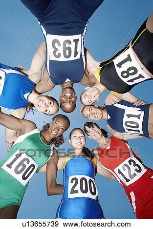 Track and field athletics smiling in a circle view from below View Large Photo Image Stock Photo - Track and field athletics smiling in a circle view from below. Fotosearch