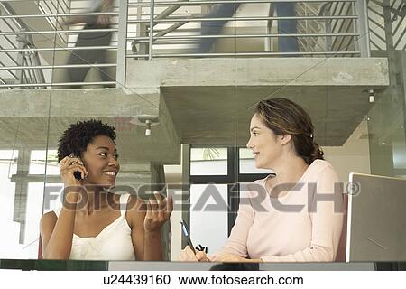 Stock Image - Two Businesswomen in Meeting. Fotosearch