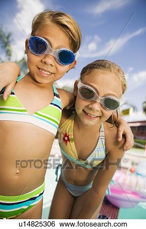 Two girls (7-9) at the pool portrait. View Large Photo Image Stock Photograph - Two girls (7-9) at the pool portrait.. Fotosearch