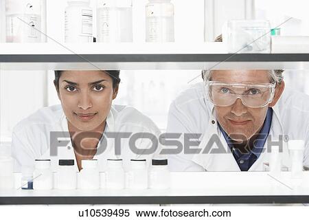 Two Lab Workers Looking Through Shelves View Large Photo Image Stock Photography - Two Lab Workers Looking Through Shelves. Fotosearch