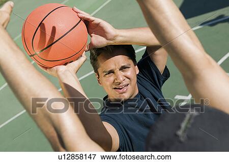 Stock Photo - Two men playing basketball elevated view.. Fotosearch