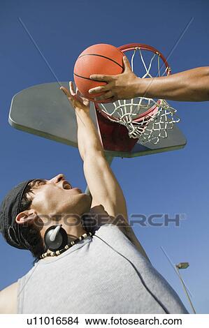 Picture - Two men playing basketball low angle view.. Fotosearch