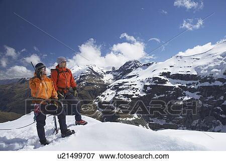 Two mountain climbers on snowy peak View Large Photo Image Stock Photo - Two mountain climbers on snowy peak. Fotosearch