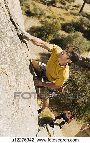 Two people Climbing on Cliff elevated view (high angle view) View Large Photo Image Stock Image - Two people Climbing on Cliff elevated view (high angle view). Fotosearch