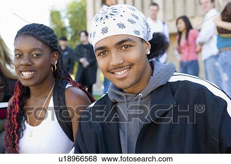 Two students smiling outdoors (portrait) View Large Photo Image Stock Photo - Two students smiling outdoors (portrait). Fotosearch