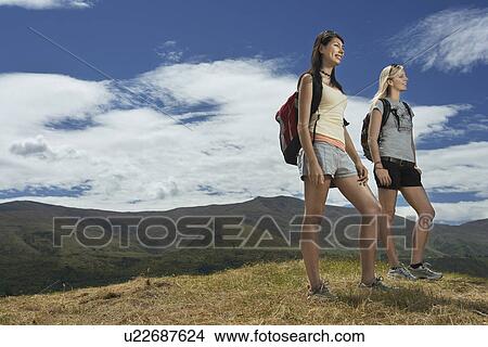 Two women hiking in hills View Large Photo Image Picture - Two women hiking in hills. Fotosearch