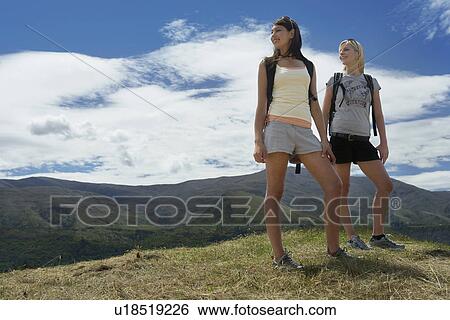 Stock Photograph - Two women hiking in hills. Fotosearch