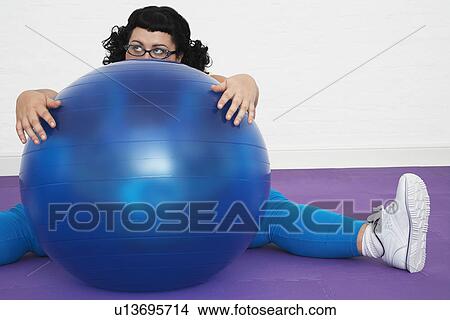 Uninspired overweight Woman sitting Behind Exercise Ball View Large Photo Image Picture - Uninspired overweight Woman sitting Behind Exercise Ball. Fotosearch