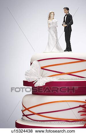 Stock Photo - Wedding Cake with Bride and Groom Figurines. Fotosearch