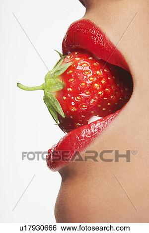 Stock Photograph - Woman Biting Strawberry. Fotosearch