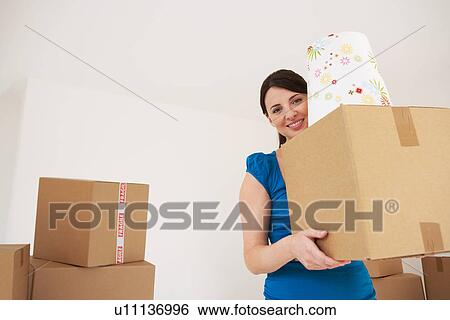 Woman carrying cardboard box View Large Photo Image Stock Photograph - Woman carrying cardboard box. Fotosearch