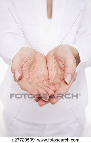 Woman Cupping Her Hands mid section View Large Photo Image Stock Photo - Woman Cupping Her Hands mid section. Fotosearch