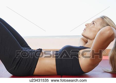 Woman Doing Sit-Ups close up side view View Large Photo Image Stock Photography - Woman Doing Sit-Ups close up side view. Fotosearch
