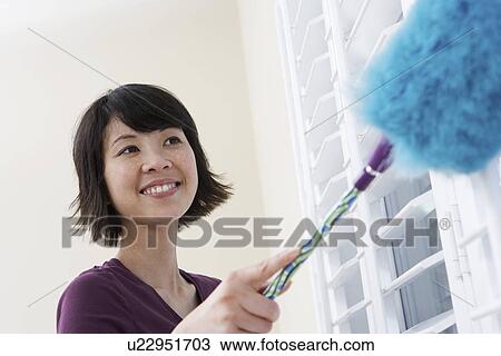 Stock Image - Woman dusting. Fotosearch