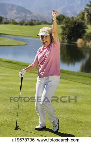 Stock Photograph - Woman gesturing on golf course (portrait). Fotosearch