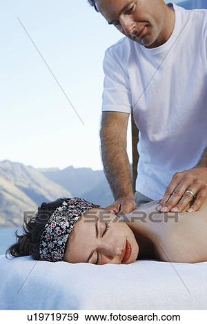 Woman getting a massage with mountains in background View Large Photo Image Stock Photo - Woman getting a massage with mountains in background. Fotosearch