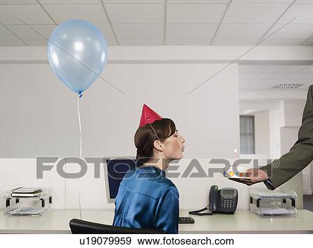 Woman having birthday party in office View Large Photo Image Stock Photo - Woman having birthday party in office. Fotosearch