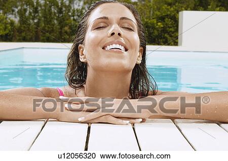 Woman in Swimming Pool resting on poolside close up ground view View Large Photo Image Stock Image - Woman in Swimming Pool resting on poolside close up ground view. Fotosearch