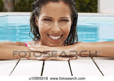 Woman in Swimming Pool resting on poolside portrait ground view View Large Photo Image Stock Photo - Woman in Swimming Pool resting on poolside portrait ground view. Fotosearch