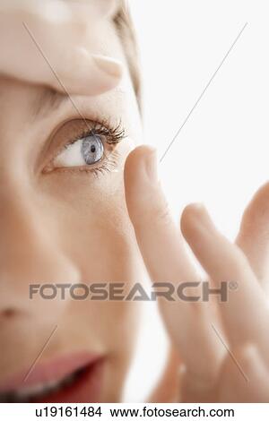 Woman Inserting Contact Lens close up of face View Large Photo Image Picture - Woman Inserting Contact Lens close up of face. Fotosearch