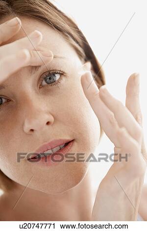 Woman Inserting Contact Lens close up of face View Large Photo Image Stock Image - Woman Inserting Contact Lens close up of face. Fotosearch