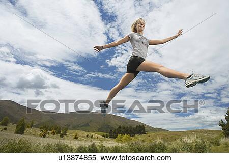 Woman leaping in hills View Large Photo Image Stock Photography - Woman leaping in hills. Fotosearch